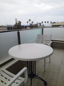 a white table and two chairs on a balcony at Port Hotel, Tasucu in Silifke