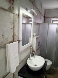 a bathroom with a sink and a mirror at Port Hotel, Tasucu in Silifke
