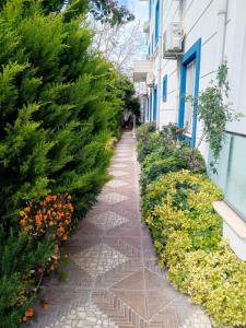 a walkway next to a building with flowers at Port Hotel, Tasucu in Silifke