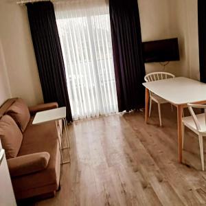a living room with a couch and a table at Port Hotel, Tasucu in Silifke