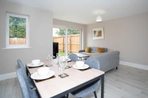a living room with a table and a couch at Cosy 3 Bedroom Home in Birmingham with Garden in Birmingham
