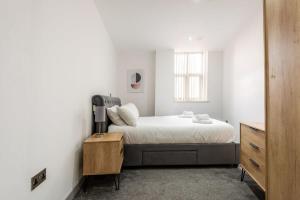 a white bedroom with a bed and a window at Modern 3 Bed Budget Apartment in Central Doncaster in Doncaster