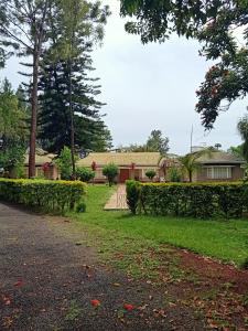 a yard with a house in the background at Nick's and Essy's place in Juja