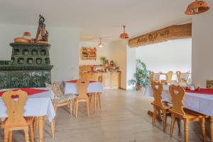 a restaurant with two tables and chairs and a kitchen at Apartments Mulej in Bled