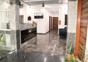 a lobby with a reception desk in a building at Blue Castle Inn in Greater Noida