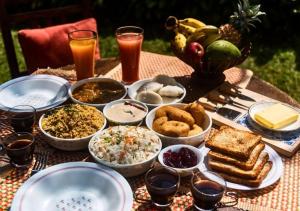 a table with plates of food and drinks on it at Blue Castle Inn in Greater Noida