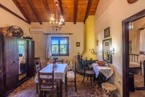 a dining room with a table and chairs at The Fairytale House Seaside Retreat in Chrani