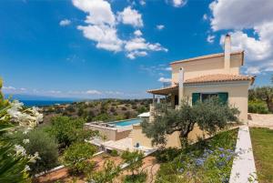 a villa with a view of the ocean at Porto Cheli Studio - Poolside Lux Getaway in Porto Heli