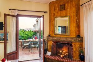 a living room with a fireplace and a mirror at Mani Garden Haven - Private Retreat in Stoupa in Levktron