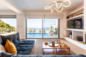 The swimming pool at or close to Aigli Luxury Villa - Seaview Panoramic Retreat