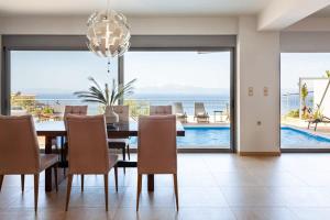 The swimming pool at or close to Aigli Luxury Villa - Seaview Panoramic Retreat