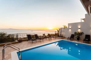 The swimming pool at or close to Aigli Luxury Villa - Seaview Panoramic Retreat