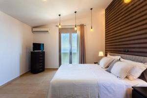 A bed or beds in a room at Aigli Luxury Villa - Seaview Panoramic Retreat