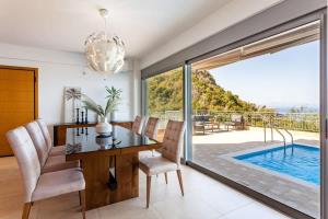 The swimming pool at or close to Aigli Luxury Villa - Seaview Panoramic Retreat