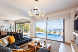 The swimming pool at or close to Aigli Luxury Villa - Seaview Panoramic Retreat