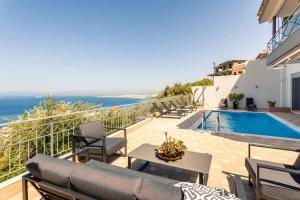 The swimming pool at or close to Aigli Luxury Villa - Seaview Panoramic Retreat