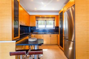A kitchen or kitchenette at Aigli Luxury Villa - Seaview Panoramic Retreat