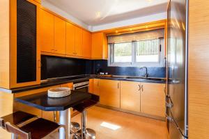 A kitchen or kitchenette at Aigli Luxury Villa - Seaview Panoramic Retreat