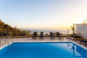 The swimming pool at or close to Aigli Luxury Villa - Seaview Panoramic Retreat