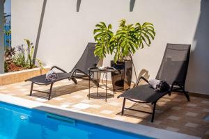The swimming pool at or close to Aigli Luxury Villa - Seaview Panoramic Retreat