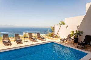 The swimming pool at or close to Aigli Luxury Villa - Seaview Panoramic Retreat