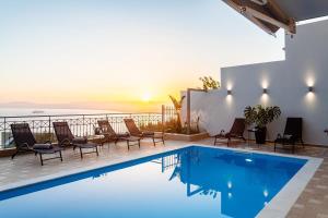 The swimming pool at or close to Aigli Luxury Villa - Seaview Panoramic Retreat