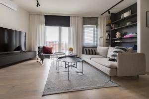 a living room with a couch and a table at Odra Apartments in Wrocław