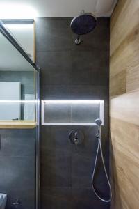 a bathroom with a shower with a shower head at Kalamata Aigli Lux Seafront Retreats- Up to 11ppl in Kalamata +35 photos