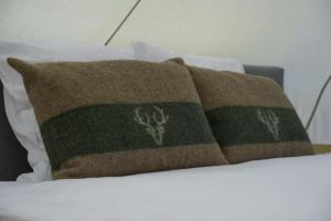 a pair of pillows sitting on a bed at Camp Pera in Täsch