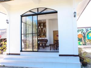 an entrance to a house with a glass door at NOGS Homestay, near Magpupungko, Siargao Island Surfings Spots in Pilar