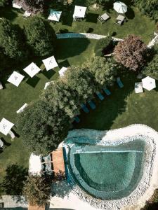 an overhead view of a swimming pool with trees and tents at Hotel Oberforsthof in Sankt Johann im Pongau