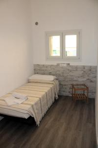 A bed or beds in a room at Rachele Guest House La Spezia