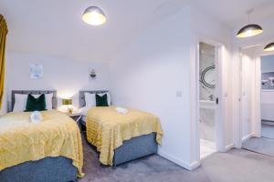 a bedroom with two beds and a walk in shower at Beautiful Manchester Home Sleeps 9 by PureStay Short Lets in Manchester