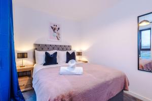 a bedroom with a large bed and a mirror at Stunning Manchester House Sleeps 10 with Parking by PureStay - Short Stays & Accommodation in Manchester +89 photos