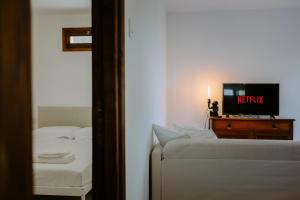 a bedroom with a bed and a tv on a table at Retreat Kritou Tera House No2 Petite Paradise in Kritou Terra