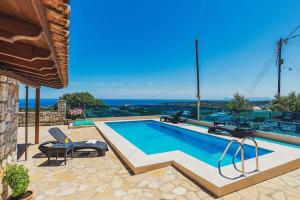a swimming pool with two lounge chairs at Sea Breeze & Stunning Views - Pool Dream Gem in Dhémbla