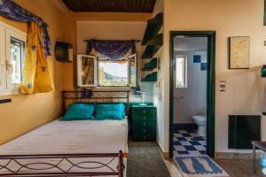 a small bedroom with a bed and a bathroom at Kyparissia Seaside Loft-Sunsets near the sea in Míloi