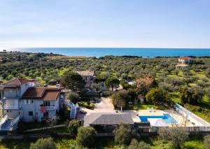 an aerial view of a house with a swimming pool and the ocean at Kyparissia Seaside Loft-Sunsets near the sea in Míloi