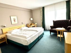 une chambre d'hôtel avec un lit et une chaise dans l'établissement Hotel & Restaurant Schönau, à Peine