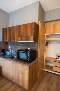a kitchen with a microwave on top of a counter at Paralion Town Apartments in Alexandroupoli