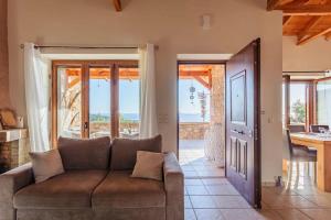 a living room with a couch and a view of the ocean at Mani Panoramic Seaviews - Luxury Summer Haven in Lévktron