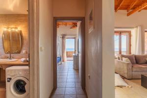 a kitchen and living room with a washer and dryer at Mani Panoramic Seaviews - Luxury Summer Haven in Lévktron