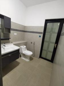 a bathroom with a toilet and a sink at Cosy apartment on the 1st floor in Curepipe