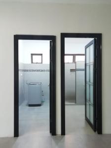 a bathroom with two mirrors and a toilet in a room at Cosy apartment on the 1st floor in Curepipe