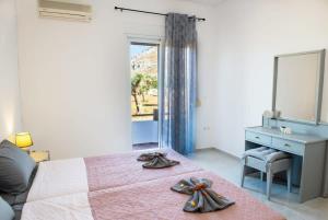 a bedroom with a bed with a dresser and a mirror at Atlantic Cave Haven-Seaside, Fully Equipped in Kolymbia