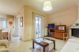 a living room with a couch and a fireplace at Spacious Urban Haven-Family Home, Perfect location in Kalamata