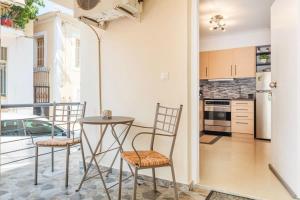 a kitchen with a table and chairs on a balcony at Kalamata Lime Studio - Cozy Gem with Private Parking in Kalamata