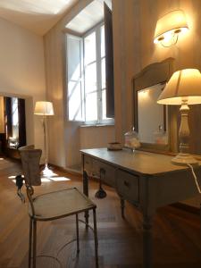 a room with a vanity with a mirror and a chair at Scappo in Umbria, Residenza Monaldeschi in Orvieto