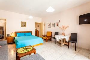 a bedroom with a bed and a living room at Kalamata City Nest - Central & Cozy Hideout in Kalamata