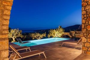 a villa with a swimming pool at night at Gerakada Exclusive-Seaview Villa with Private Pool in Koroni